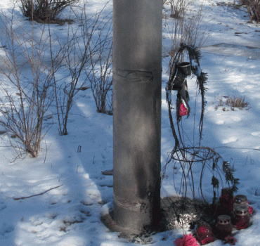 Burnt wreath near the memorial cross of Stalinist victims in Baranavichy